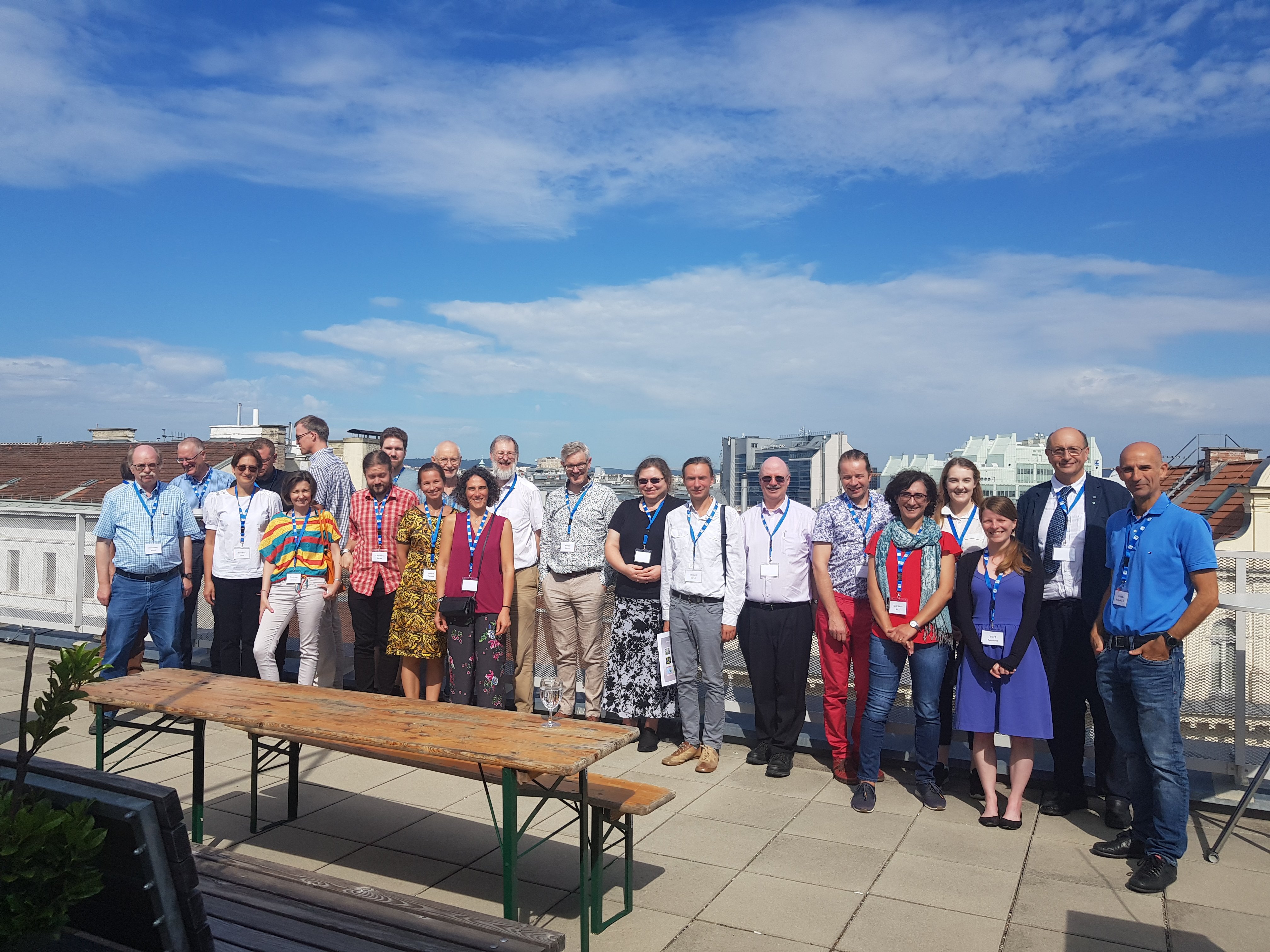 Group of people in the sun on a roof.