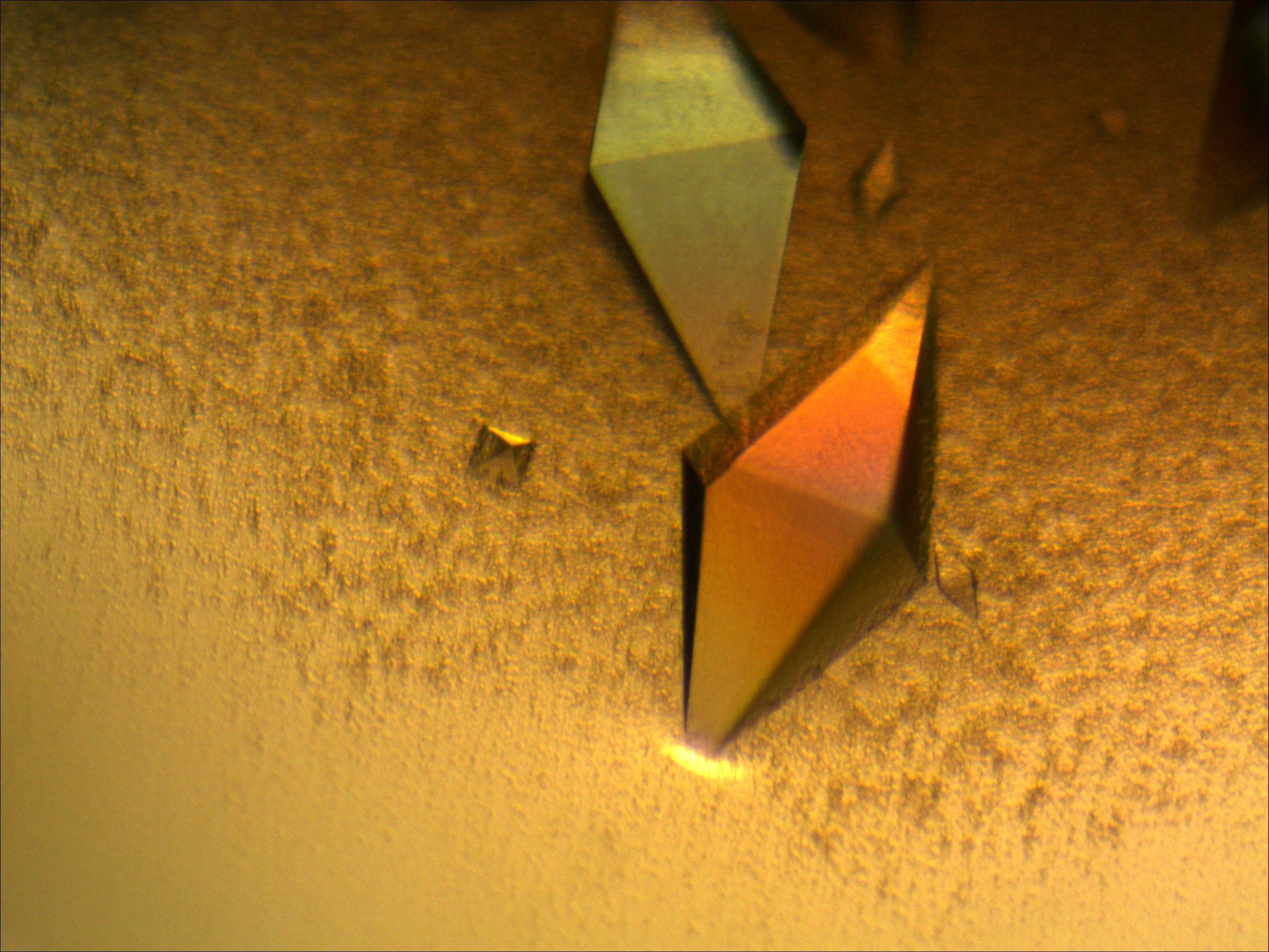 Two large diamond shaped crystals on yellow background