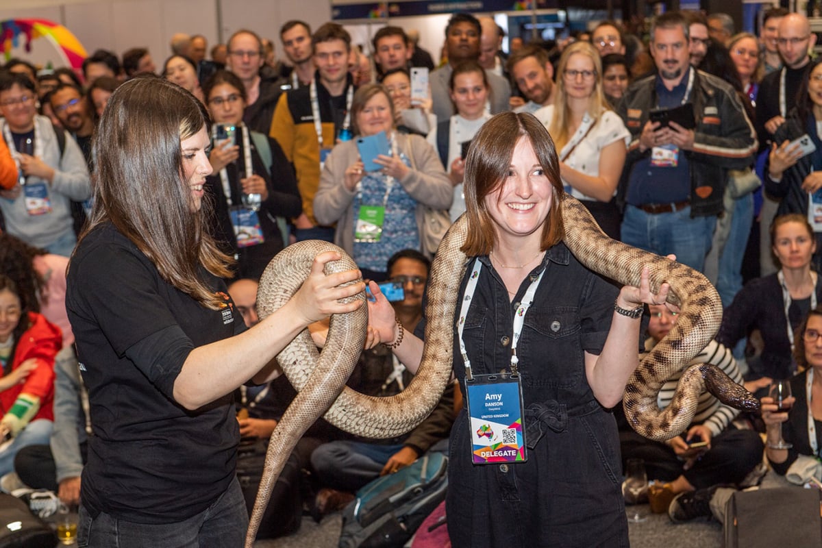 woman with large snake over shoulders
