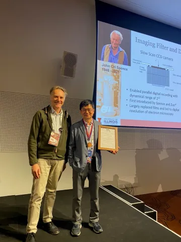 Jian-Min Zuo (right) receives his medal and certificate from Mauro Gemmi, Chair of the IUCr Commission on Electron Crystallography, at the 26th IUCr Congress in Melbourne, Australia, in August 2023. Photo courtesy of Samar Hasnain.