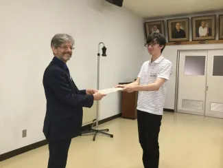 A person being handed a certificate