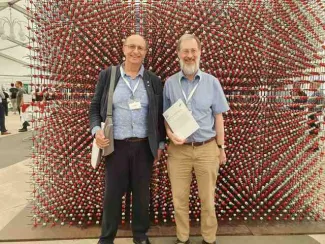Two people stood in front of an exhibit