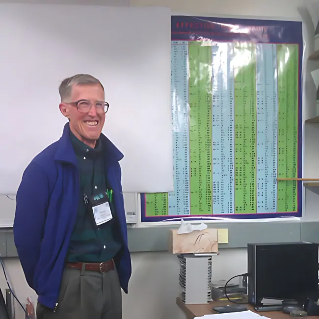 man next to poster
