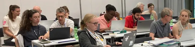 students in classroom with laptops